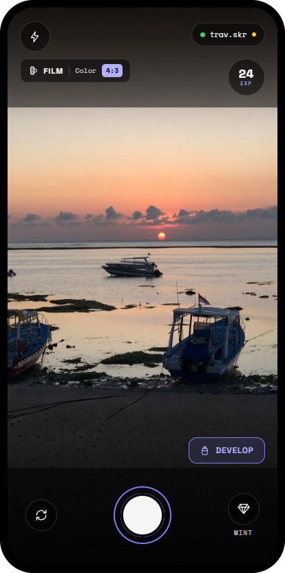Momints camera screen shooting a sunset over moored boats